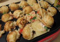 Takoyaki rolling on electric pan